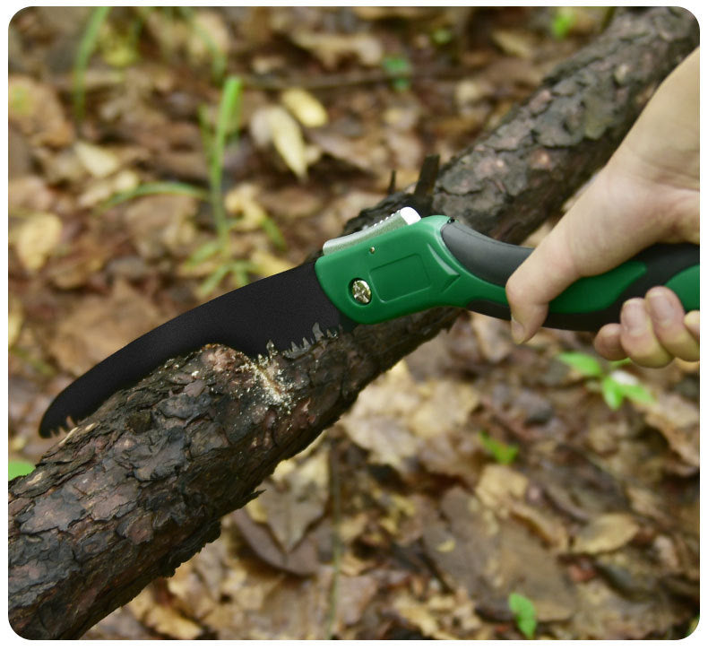 Folding pruning saw cutting through tree branch