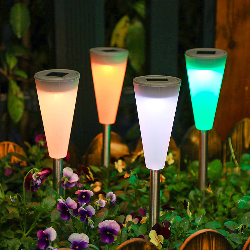 Solar stake lights glowing among flowers at dusk