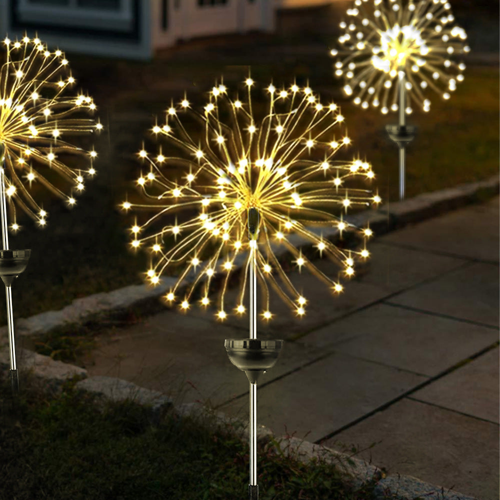 Colourful solar firework stake lights in flower bed